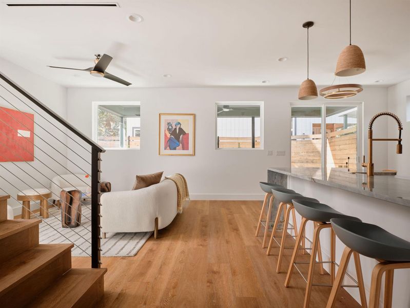 Living area with light wood-style flooring, stairway, and recessed lighting Living area with light wood-style flooring, stairway, and recessed lighting