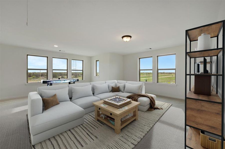 Carpeted living room featuring healthy amount of natural light