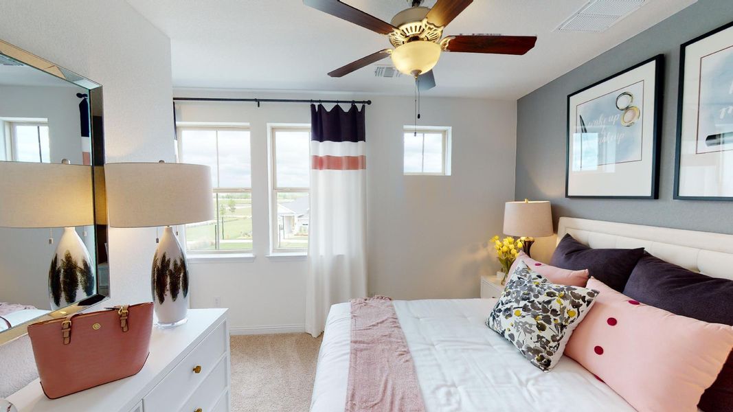 Bedroom featuring light carpet and a ceiling fan