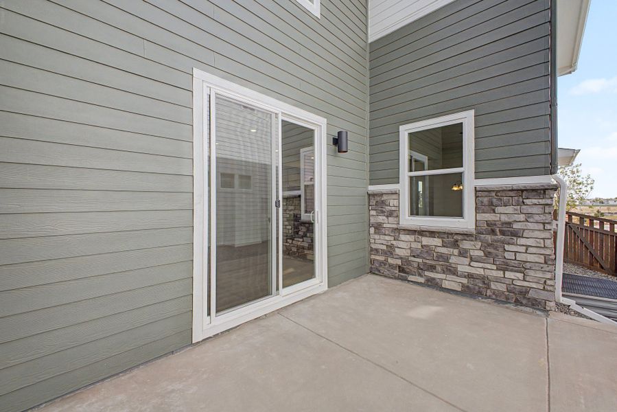 Exterior details and patio area of a home in Painted Prairie, Aurora (Image 21).