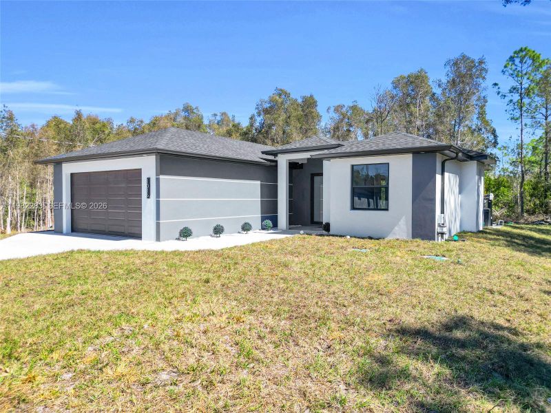 Front exterior of a new home in , Lehigh Acres, FL, highlighting curb appeal (Image 20).