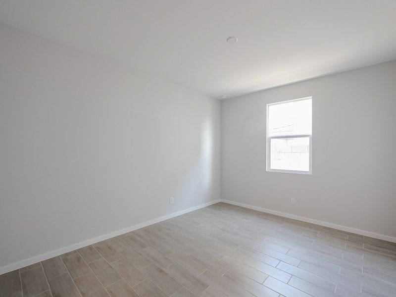 A room with a tile floor and windows.