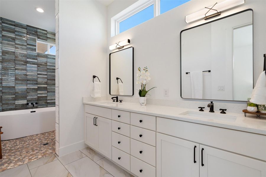 Luxurious primary suite with a spa-inspired en-suite bathroom and custom walk-in closet.