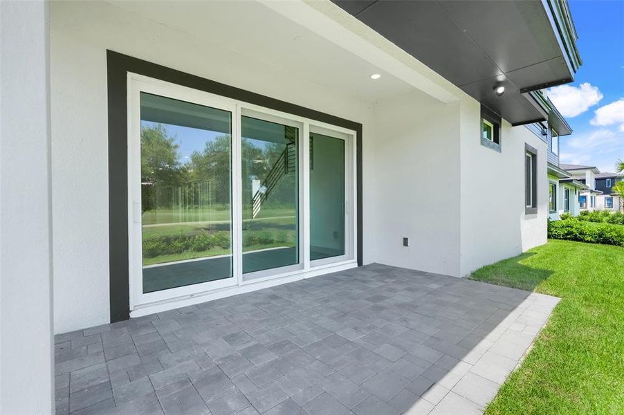 Exterior details and patio area of a home in Hampton Green at Providence, Davenport (Image 37).
