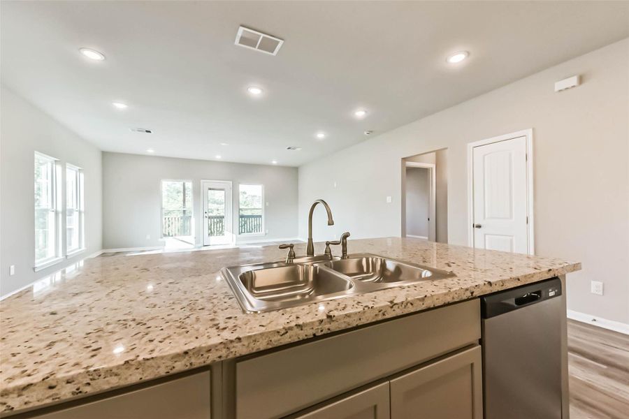 Take a look at the bright and airy space flowing seamlessly from the kitchen into the living area.