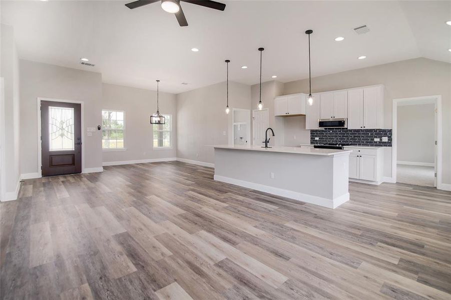 Featuring a stunning open floor plan with soaring ceilings, recessed lighting, and stylish contemporary fixtures.