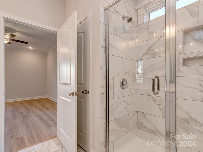 Primary shower w/transom window and linen closet