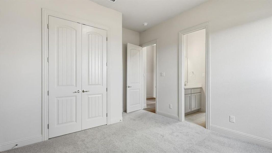 Light grey carpeting with white baseboards throughout