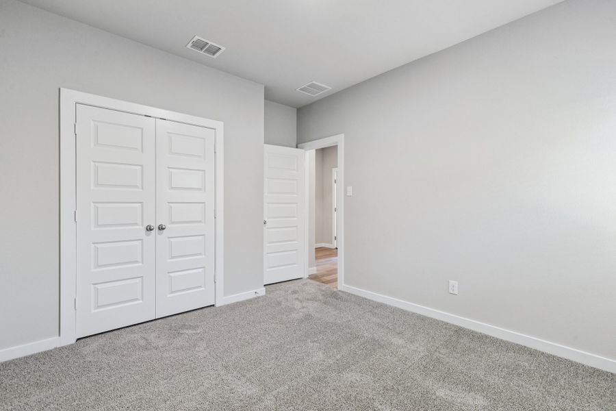 Bedroom in the Heisman home plan by Trophy Signature Homes – REPRESENTATIVE PHOTO Bedroom in the Heisman home plan by Trophy Signature Homes – REPRESENTATIVE PHOTO