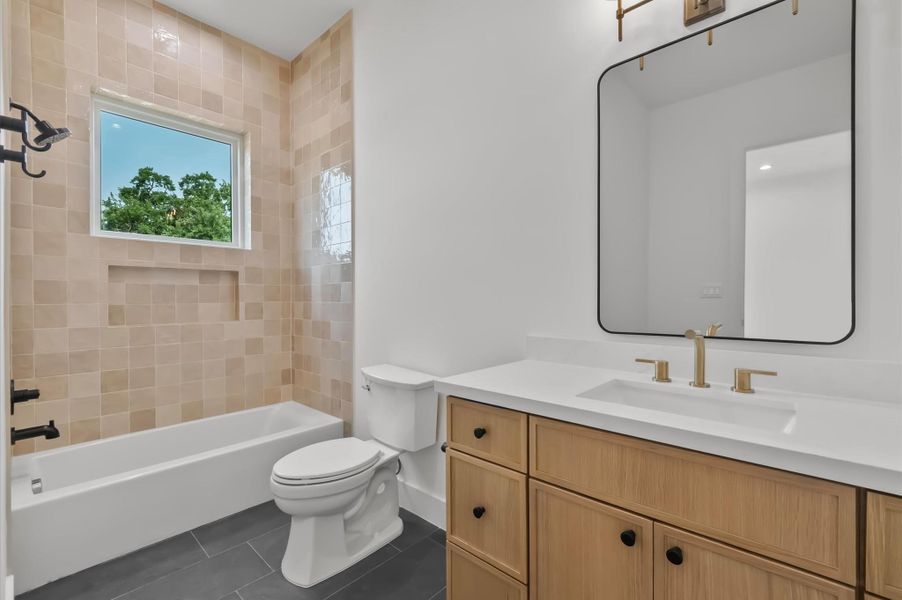 Moody secondary bath featuring spacious vanity and quality finishes. Moody secondary bath featuring spacious vanity and quality finishes.