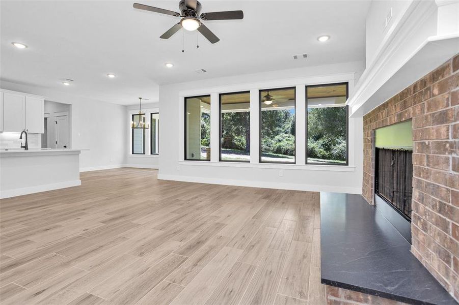 Wide open family room showing back patio, kitchen and dining area.