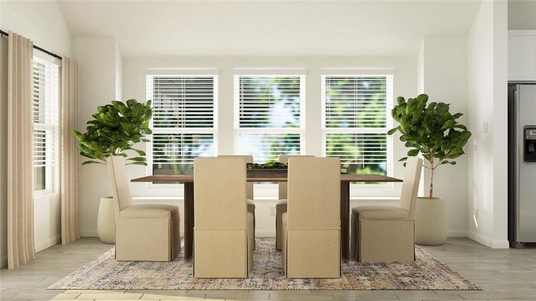 Dining space with light wood finished floors and healthy amount of natural light Dining space with light wood finished floors and healthy amount of natural light