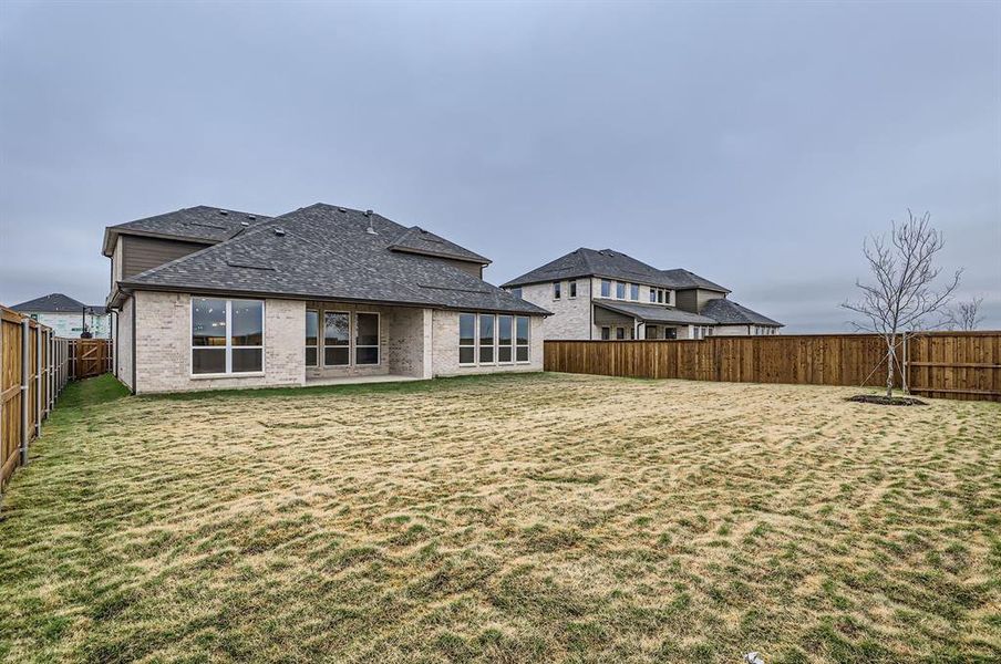 Rear view of property featuring a lawn