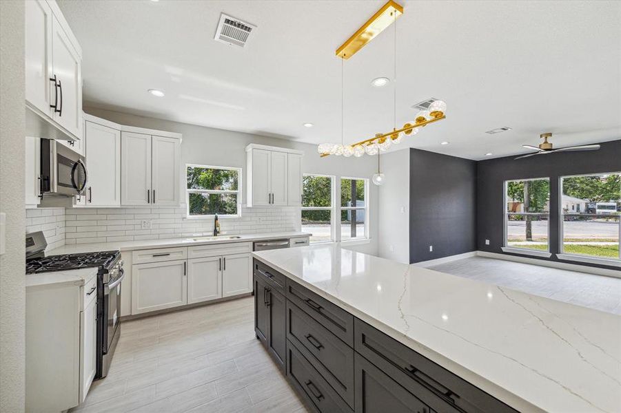 View of the kitchen with an oversized quartz countertop