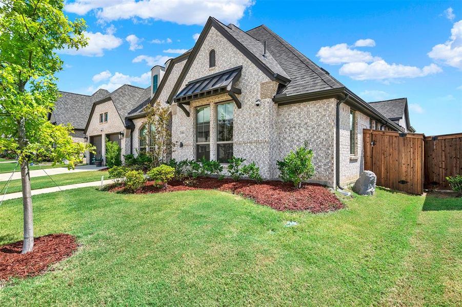 French provincial home featuring brick siding and a shingled roof