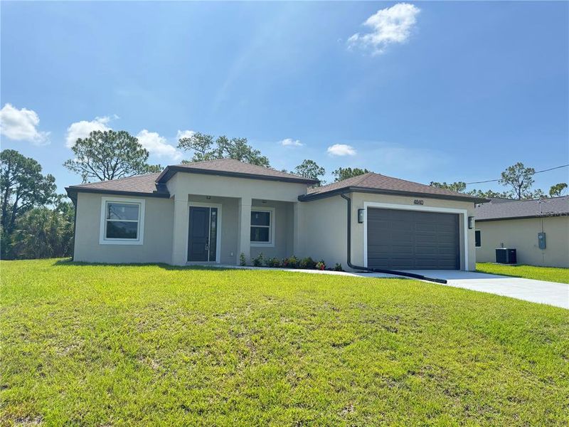 Front exterior of a new home in , North Port, FL, highlighting curb appeal (Image 1). Front exterior of a new home in , North Port, FL, highlighting curb appeal (Image 1).