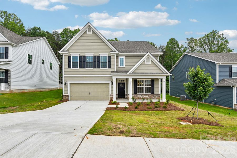 Front exterior of a new home in Falls Cove, Troutman, NC, highlighting curb appeal (Image 2). Front exterior of a new home in Falls Cove, Troutman, NC, highlighting curb appeal (Image 2).