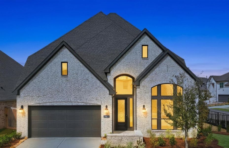 Front exterior of a new home in Bridgeland 50', Cypress, TX, highlighting curb appeal (Image 2). Front exterior of a new home in Bridgeland 50', Cypress, TX, highlighting curb appeal (Image 2).