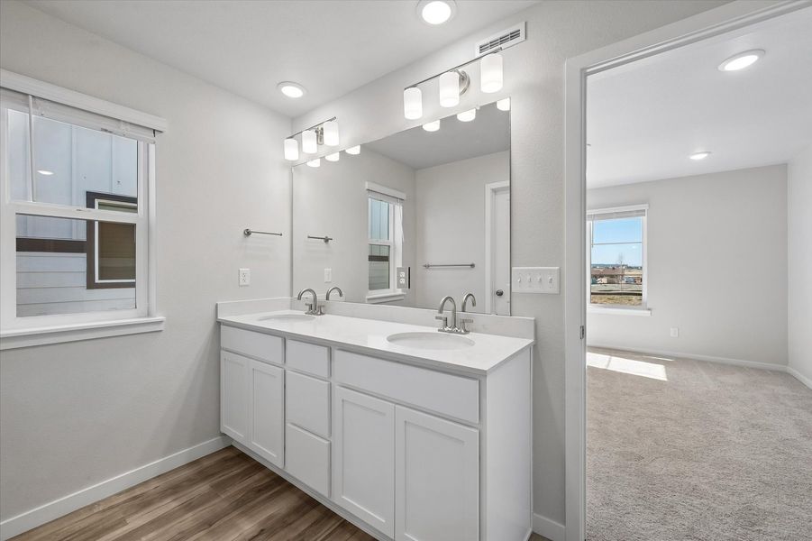 A bathroom with a large mirror.