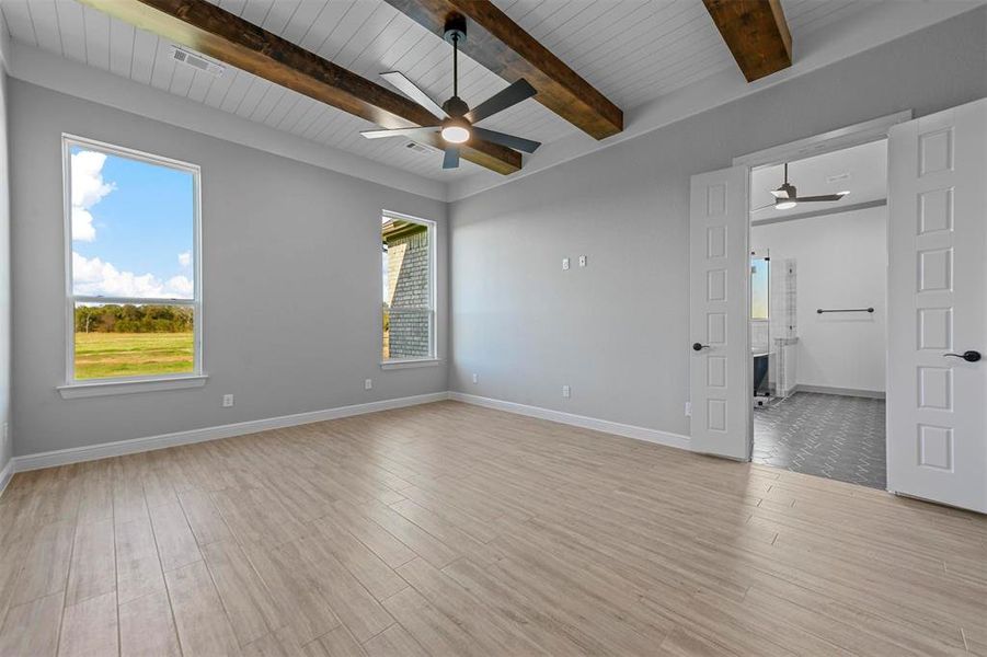 Spare room with wood ceiling, ceiling fan, beamed ceiling, and light hardwood / wood-style floors