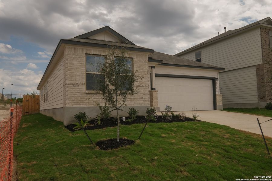 Front exterior of a new home in Hunters Ranch, San Antonio, TX, highlighting curb appeal (Image 19). Front exterior of a new home in Hunters Ranch, San Antonio, TX, highlighting curb appeal (Image 19).