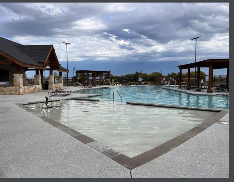 Community pool featuring a patio area Community pool featuring a patio area