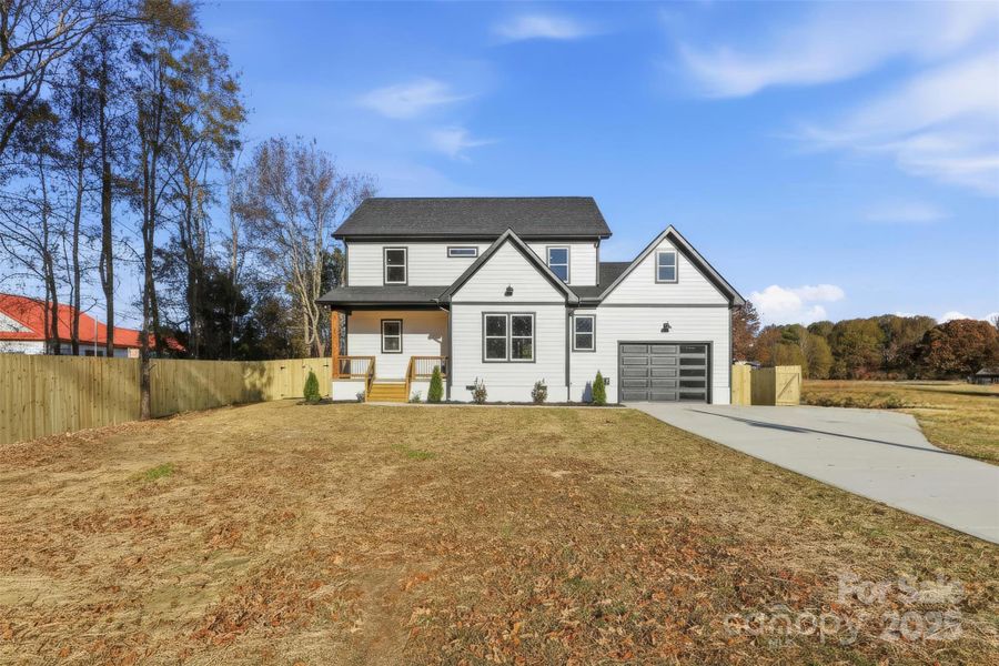 Front exterior of a new home in , Monroe, NC, highlighting curb appeal (Image 24).