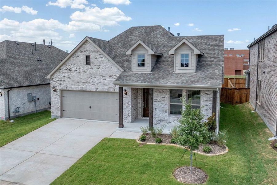 View of front of property featuring roof with shingles, brick siding, concrete driveway, and an attached garage View of front of property featuring roof with shingles, brick siding, concrete driveway, and an attached garage