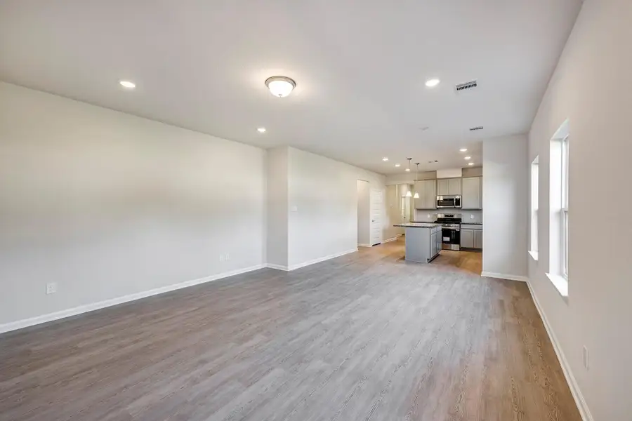 The Mockingbird II- Family Room and Dining Area into Kitchen The Mockingbird II- Family Room and Dining Area into Kitchen