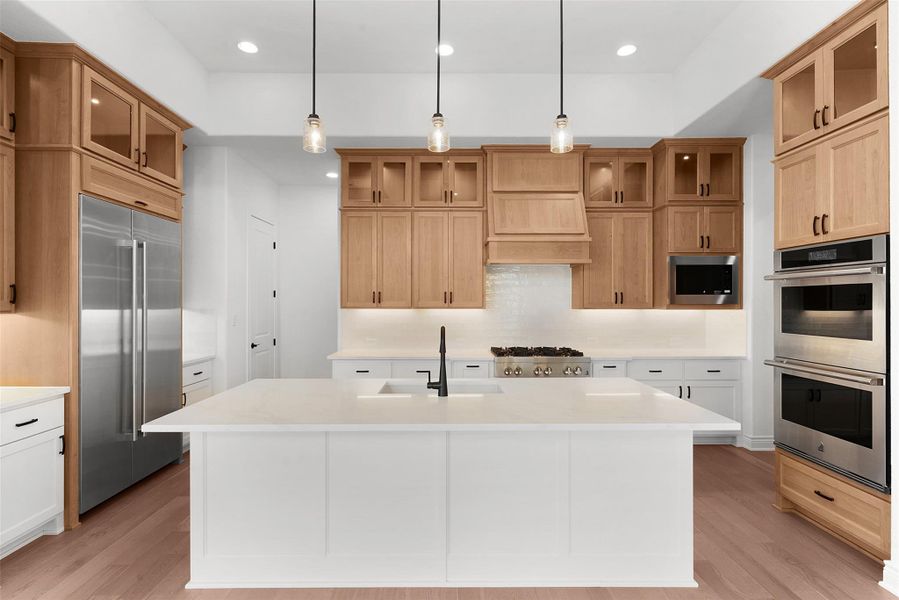 Culinary aspirations come alive in this meticulously appointed kitchen, featuring a spacious island and top-tier stainless steel appliances.
