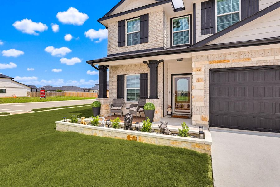 Close-up of landscaping and extended front porch.