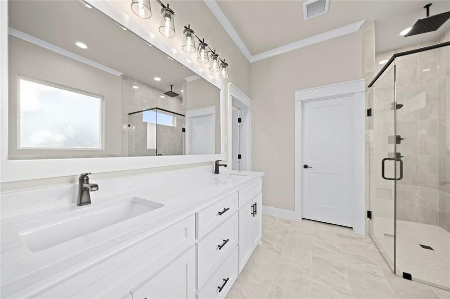 Full bath featuring a stall shower, ornamental molding, double vanity, and light tile patterned flooring