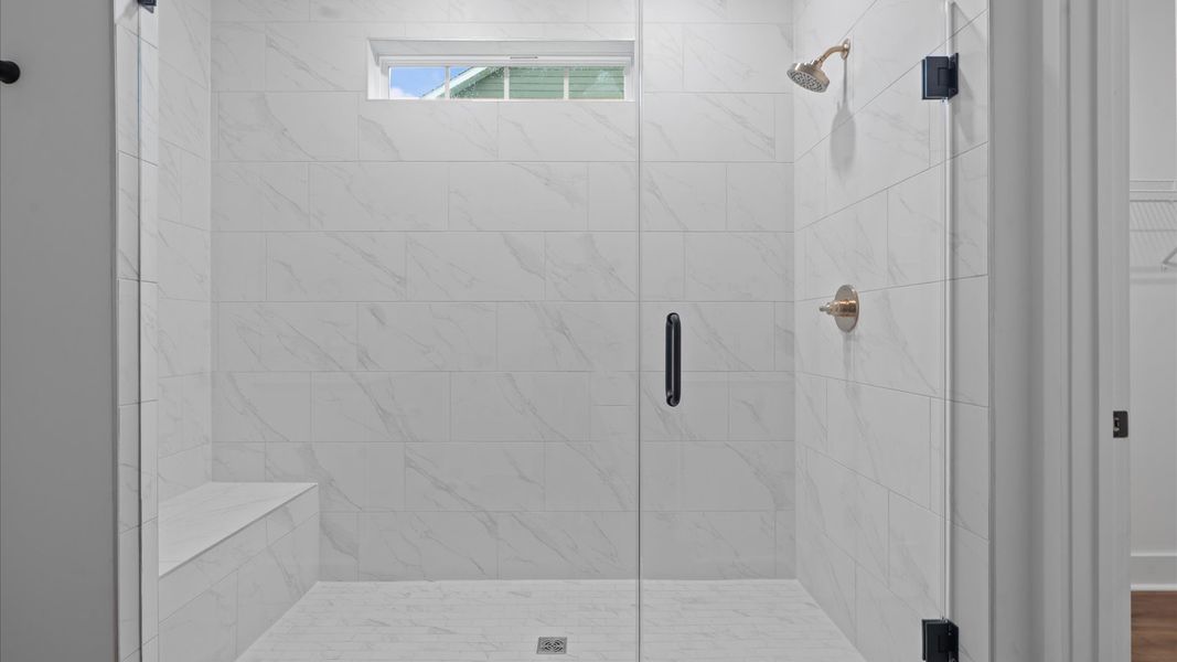 First-rate primary bathroom offering an elegant tiled walk-in shower and separate sinks with superior style