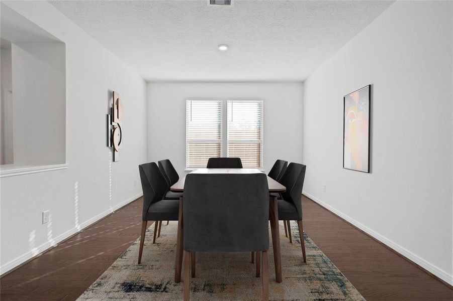 Make memories gathered around the table with your family and friends! This flex space is featured here as a dining room and it features high ceilings, large windows with privacy blinds, and easy access to your kitchen and living room.