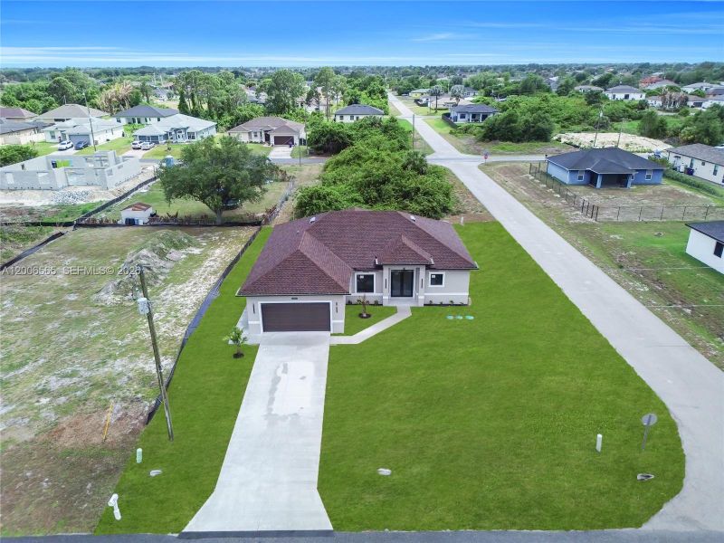 Front exterior of a new home in , Lehigh Acres, FL, highlighting curb appeal (Image 19).