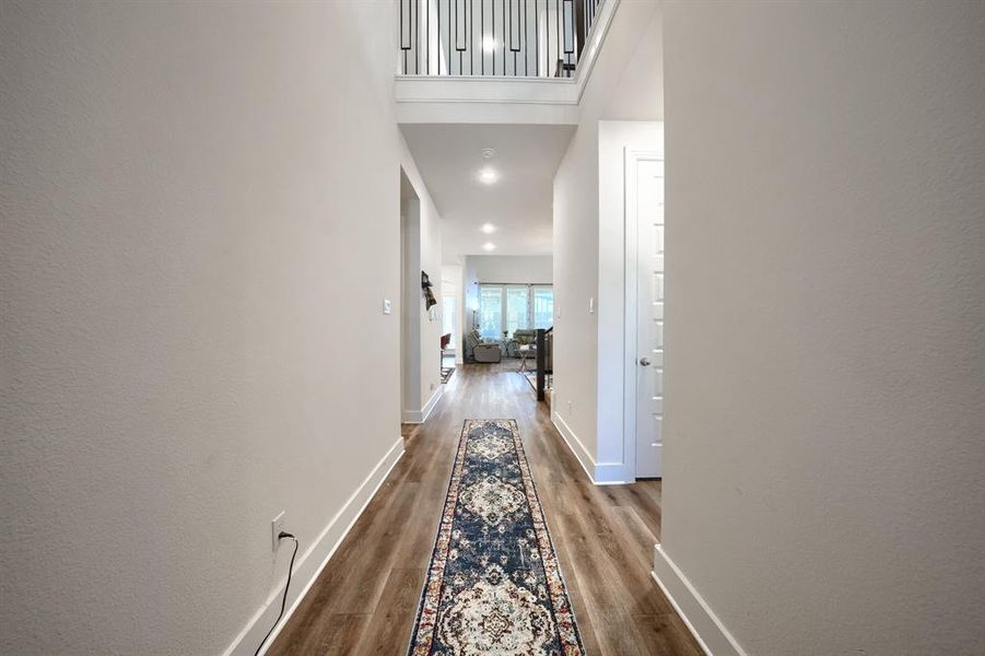 Hall featuring hardwood / wood-style floors and a high ceiling