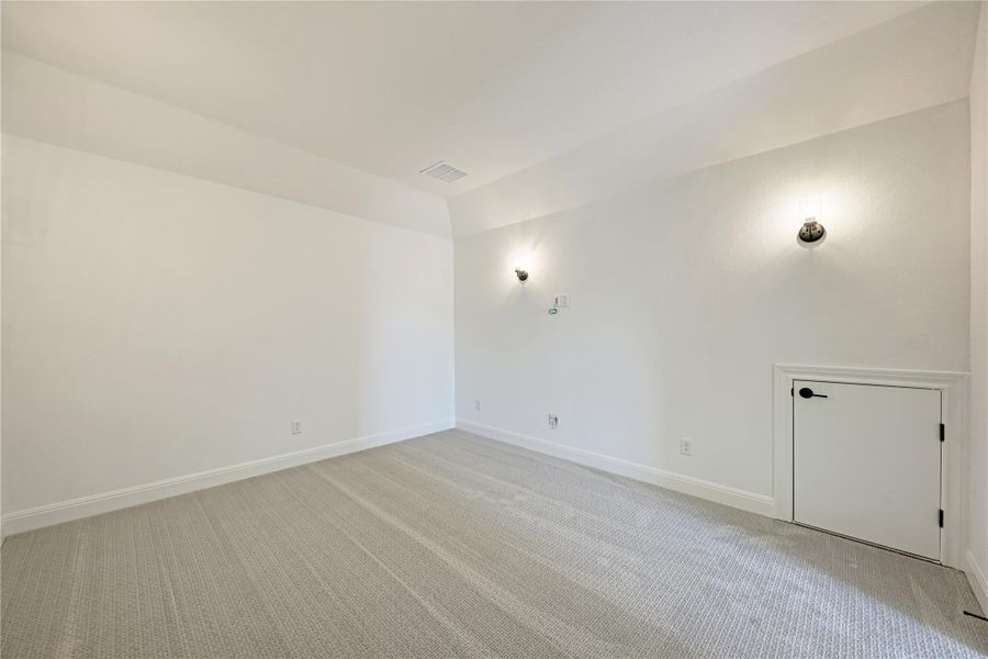 Carpeted interior space with white walls and baseboards