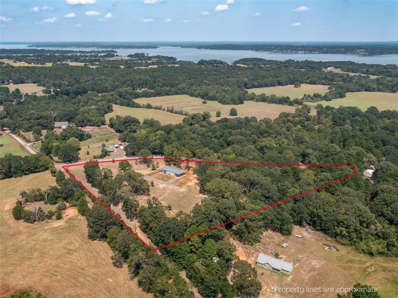 Aerial overview of property's location featuring a large body of water and property boundaries highlighted