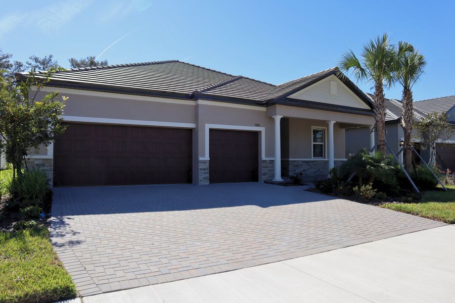 Front exterior of a new home in Angeline Active Adult: Active Adult Estates, Land O' Lakes, FL, highlighting curb appeal (Image 1).