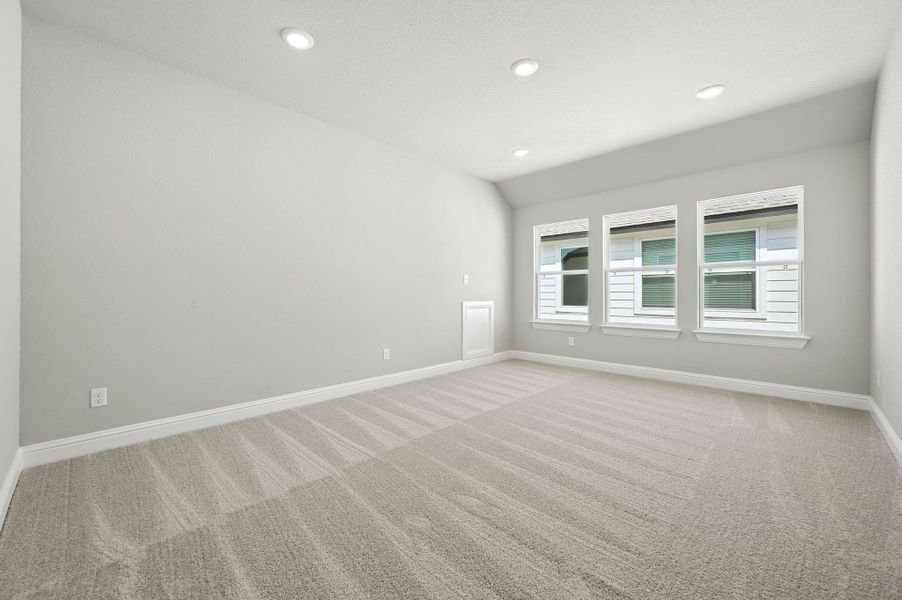 Unfurnished room with light colored carpet, recessed lighting, and vaulted ceiling