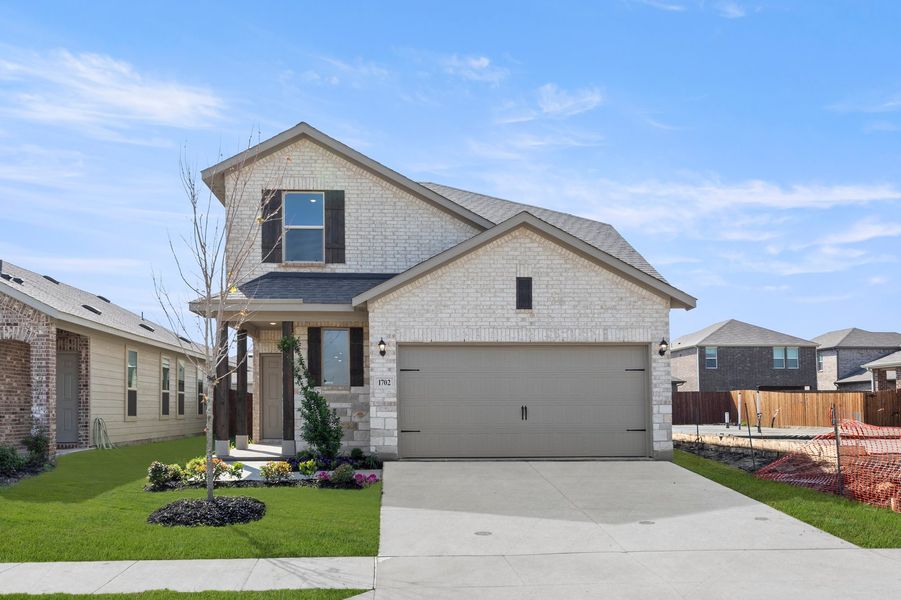 Front exterior of a new home in Creekside Ranch, Blue Ridge, TX, highlighting curb appeal (Image 1). Front exterior of a new home in Creekside Ranch, Blue Ridge, TX, highlighting curb appeal (Image 1).