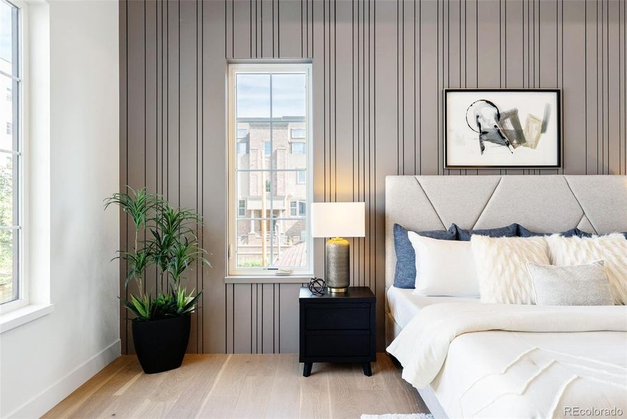 Spacious primary suite is infused with light