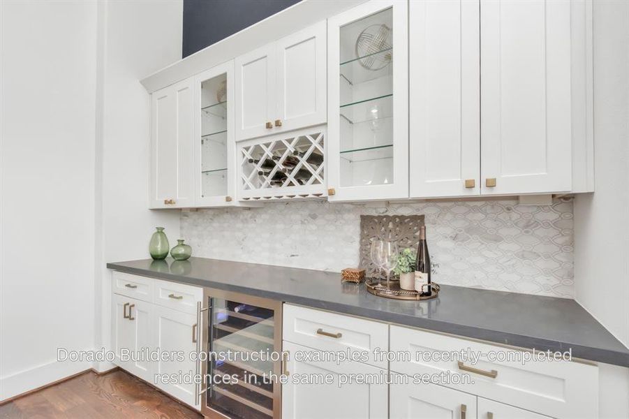 **THIS PHOTO IS OF A PREVIOUS BUILT HOME** THIS HOME WILL BE THE SAME FLOORPLAN BUT WILL HAVE DIFFERENT FINISHES - The entertaining buffet in the dining room includes a wine rack and wine refrigerator, along with plenty of storage.