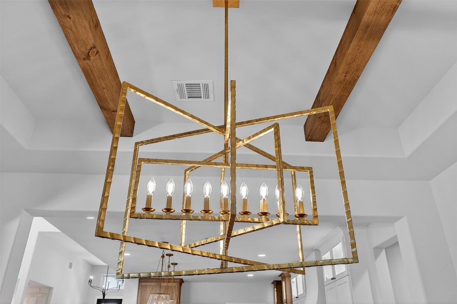 A statement chandelier anchors the room with understated drama.