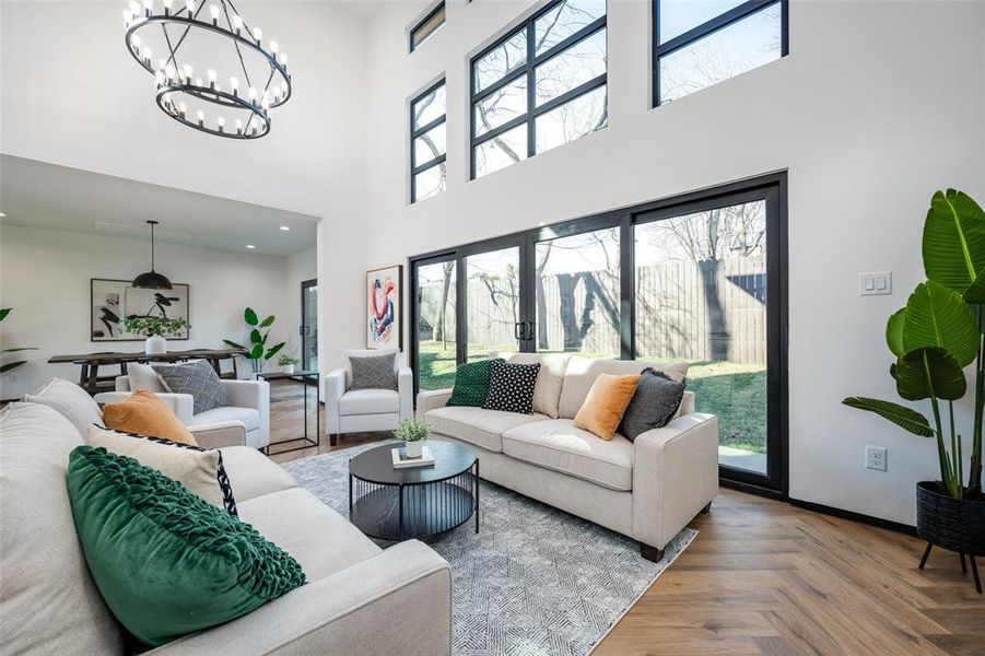 Living area with a towering ceiling and a chandelier Living area with a towering ceiling and a chandelier