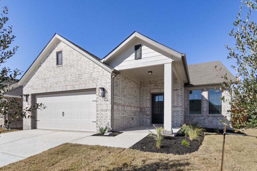 Front exterior of a new home in Crosswinds, Kyle, TX, highlighting curb appeal (Image 2). Front exterior of a new home in Crosswinds, Kyle, TX, highlighting curb appeal (Image 2).