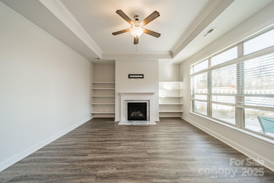 Family room with gas fireplace, trey ceilings and lots of natural light.