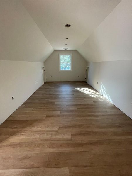 Oversized upstairs bonus room with sloped ceilings, perfect for an office, media space, or additional living area. Oversized upstairs bonus room with sloped ceilings, perfect for an office, media space, or additional living area.