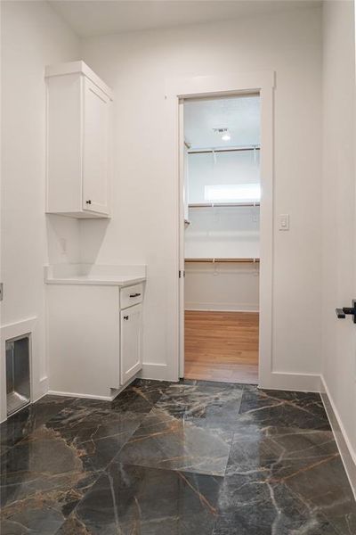 Clothes washing area featuring dark wood-type flooring