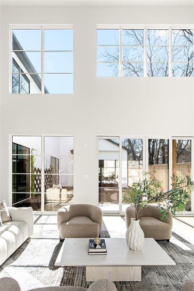 Double-height ceilings complement the expansive wall of windows, providing abundant natural light